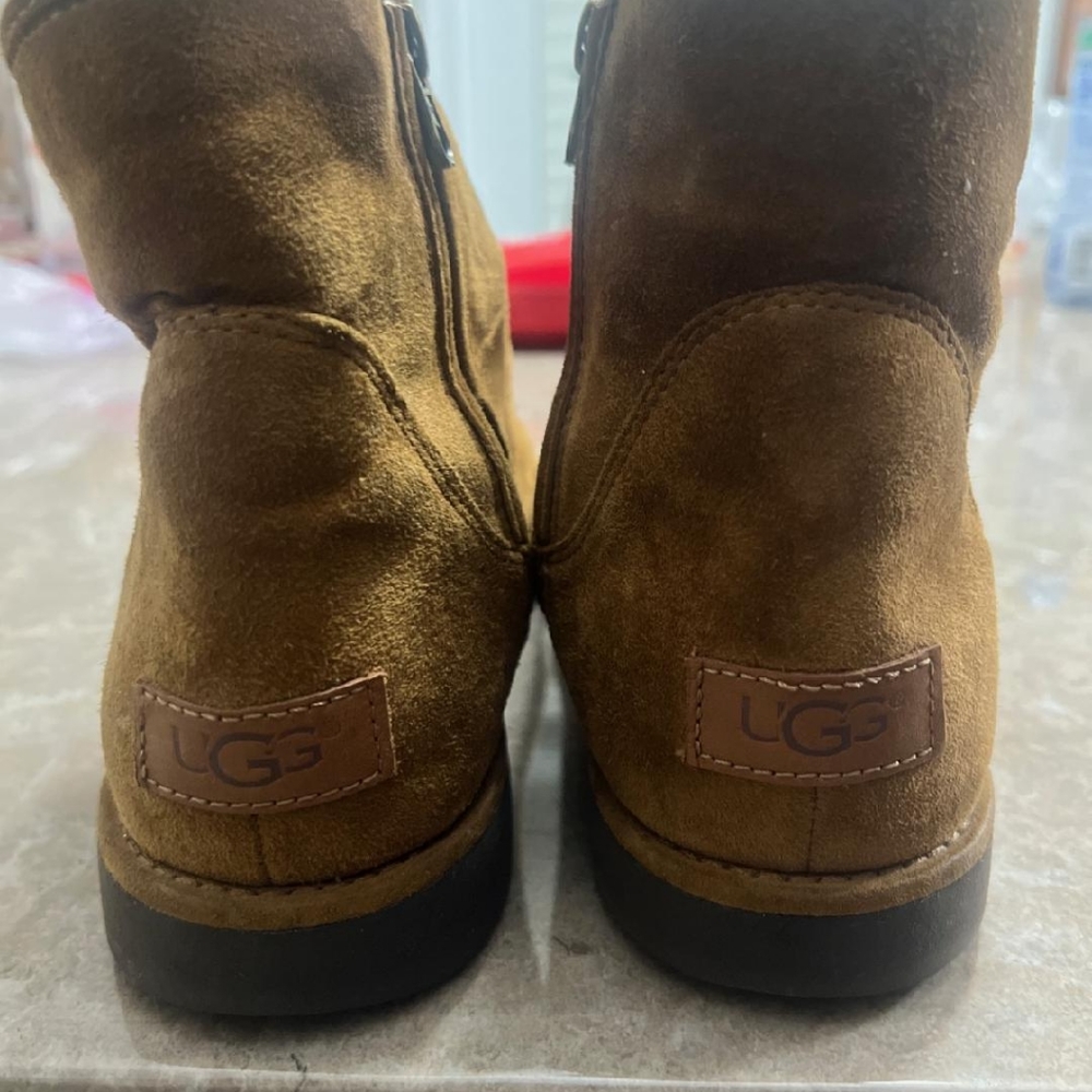 A brown pair of UGG boots size 11